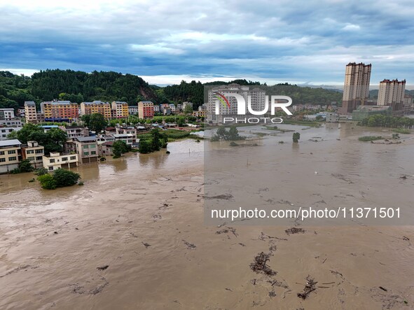 Aerial photo is showing houses and fields along the Wuyang River's Cenggong and Zhenyuan Yangping sections being flooded in Qiandongnan Pref...