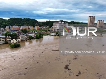 Aerial photo is showing houses and fields along the Wuyang River's Cenggong and Zhenyuan Yangping sections being flooded in Qiandongnan Pref...