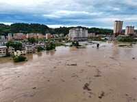 Aerial photo is showing houses and fields along the Wuyang River's Cenggong and Zhenyuan Yangping sections being flooded in Qiandongnan Pref...