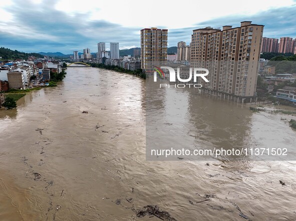 Aerial photo is showing houses and fields along the Wuyang River's Cenggong and Zhenyuan Yangping sections being flooded in Qiandongnan Pref...