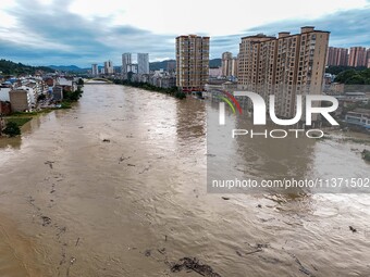 Aerial photo is showing houses and fields along the Wuyang River's Cenggong and Zhenyuan Yangping sections being flooded in Qiandongnan Pref...