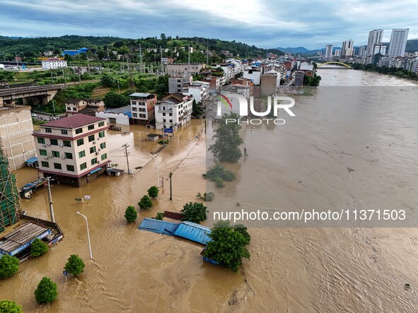 Aerial photo is showing houses and fields along the Wuyang River's Cenggong and Zhenyuan Yangping sections being flooded in Qiandongnan Pref...