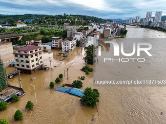 Aerial photo is showing houses and fields along the Wuyang River's Cenggong and Zhenyuan Yangping sections being flooded in Qiandongnan Pref...