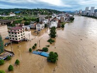 Aerial photo is showing houses and fields along the Wuyang River's Cenggong and Zhenyuan Yangping sections being flooded in Qiandongnan Pref...