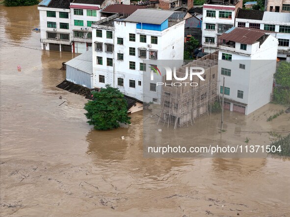 Aerial photo is showing houses and fields along the Wuyang River's Cenggong and Zhenyuan Yangping sections being flooded in Qiandongnan Pref...