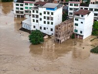 Aerial photo is showing houses and fields along the Wuyang River's Cenggong and Zhenyuan Yangping sections being flooded in Qiandongnan Pref...