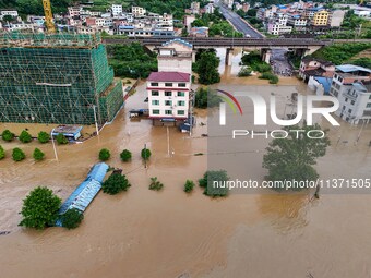 Aerial photo is showing houses and fields along the Wuyang River's Cenggong and Zhenyuan Yangping sections being flooded in Qiandongnan Pref...