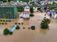 Aerial photo is showing houses and fields along the Wuyang River's Cenggong and Zhenyuan Yangping sections being flooded in Qiandongnan Pref...