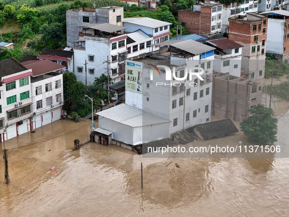 Aerial photo is showing houses and fields along the Wuyang River's Cenggong and Zhenyuan Yangping sections being flooded in Qiandongnan Pref...