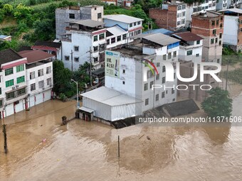 Aerial photo is showing houses and fields along the Wuyang River's Cenggong and Zhenyuan Yangping sections being flooded in Qiandongnan Pref...