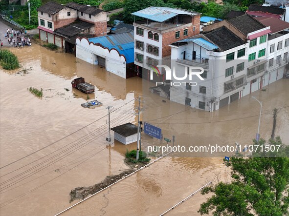 Aerial photo is showing houses and fields along the Wuyang River's Cenggong and Zhenyuan Yangping sections being flooded in Qiandongnan Pref...