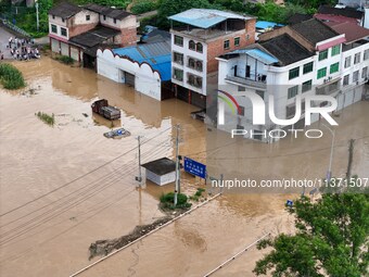 Aerial photo is showing houses and fields along the Wuyang River's Cenggong and Zhenyuan Yangping sections being flooded in Qiandongnan Pref...