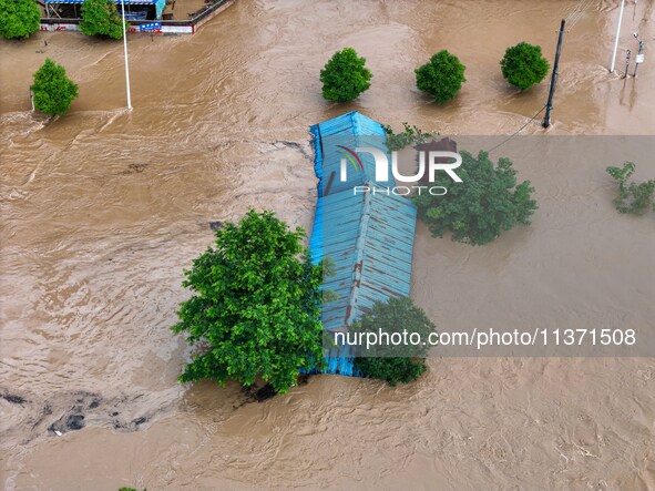 Aerial photo is showing houses and fields along the Wuyang River's Cenggong and Zhenyuan Yangping sections being flooded in Qiandongnan Pref...