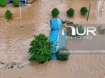 Aerial photo is showing houses and fields along the Wuyang River's Cenggong and Zhenyuan Yangping sections being flooded in Qiandongnan Pref...