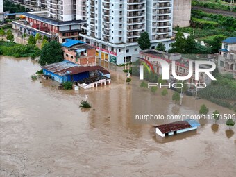 Aerial photo is showing houses and fields along the Wuyang River's Cenggong and Zhenyuan Yangping sections being flooded in Qiandongnan Pref...