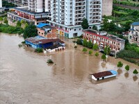 Aerial photo is showing houses and fields along the Wuyang River's Cenggong and Zhenyuan Yangping sections being flooded in Qiandongnan Pref...