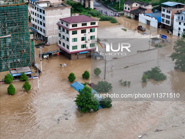 Aerial photo is showing houses and fields along the Wuyang River's Cenggong and Zhenyuan Yangping sections being flooded in Qiandongnan Pref...