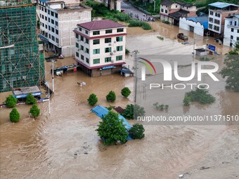 Aerial photo is showing houses and fields along the Wuyang River's Cenggong and Zhenyuan Yangping sections being flooded in Qiandongnan Pref...