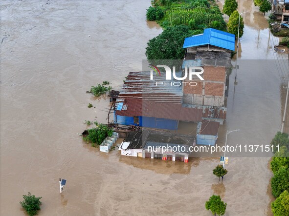 Aerial photo is showing houses and fields along the Wuyang River's Cenggong and Zhenyuan Yangping sections being flooded in Qiandongnan Pref...