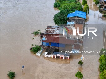 Aerial photo is showing houses and fields along the Wuyang River's Cenggong and Zhenyuan Yangping sections being flooded in Qiandongnan Pref...