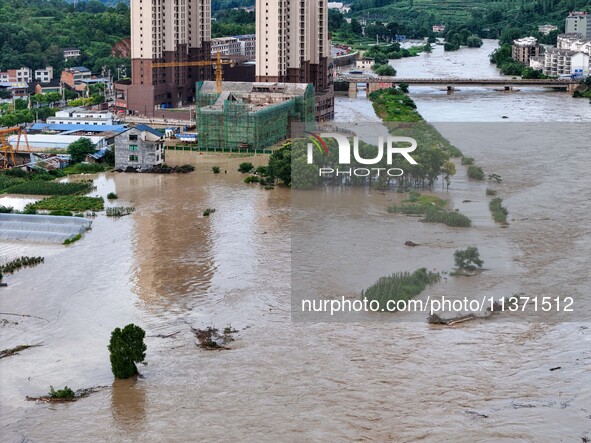 Aerial photo is showing houses and fields along the Wuyang River's Cenggong and Zhenyuan Yangping sections being flooded in Qiandongnan Pref...