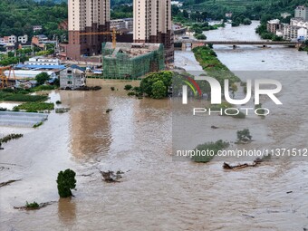 Aerial photo is showing houses and fields along the Wuyang River's Cenggong and Zhenyuan Yangping sections being flooded in Qiandongnan Pref...