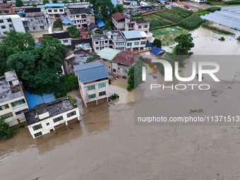 Aerial photo is showing houses and fields along the Wuyang River's Cenggong and Zhenyuan Yangping sections being flooded in Qiandongnan Pref...