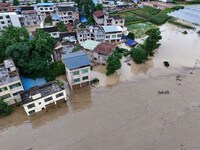 Aerial photo is showing houses and fields along the Wuyang River's Cenggong and Zhenyuan Yangping sections being flooded in Qiandongnan Pref...