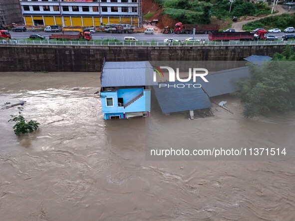 Aerial photo is showing houses and fields along the Wuyang River's Cenggong and Zhenyuan Yangping sections being flooded in Qiandongnan Pref...