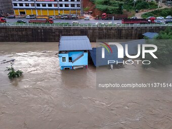 Aerial photo is showing houses and fields along the Wuyang River's Cenggong and Zhenyuan Yangping sections being flooded in Qiandongnan Pref...