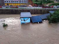 Aerial photo is showing houses and fields along the Wuyang River's Cenggong and Zhenyuan Yangping sections being flooded in Qiandongnan Pref...