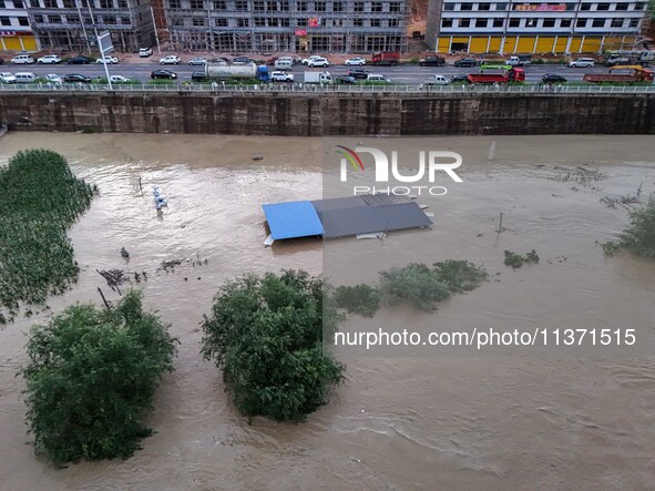 Aerial photo is showing houses and fields along the Wuyang River's Cenggong and Zhenyuan Yangping sections being flooded in Qiandongnan Pref...