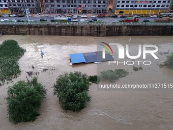 Aerial photo is showing houses and fields along the Wuyang River's Cenggong and Zhenyuan Yangping sections being flooded in Qiandongnan Pref...