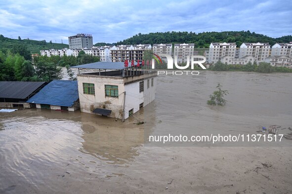 Aerial photo is showing houses and fields along the Wuyang River's Cenggong and Zhenyuan Yangping sections being flooded in Qiandongnan Pref...