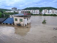 Aerial photo is showing houses and fields along the Wuyang River's Cenggong and Zhenyuan Yangping sections being flooded in Qiandongnan Pref...