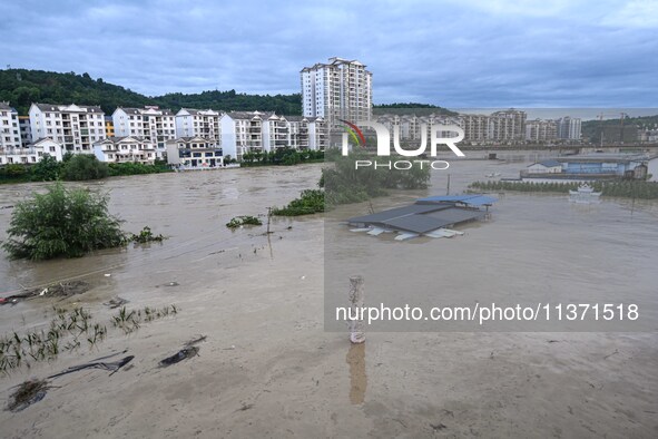 Aerial photo is showing houses and fields along the Wuyang River's Cenggong and Zhenyuan Yangping sections being flooded in Qiandongnan Pref...