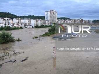 Aerial photo is showing houses and fields along the Wuyang River's Cenggong and Zhenyuan Yangping sections being flooded in Qiandongnan Pref...