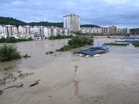 Aerial photo is showing houses and fields along the Wuyang River's Cenggong and Zhenyuan Yangping sections being flooded in Qiandongnan Pref...