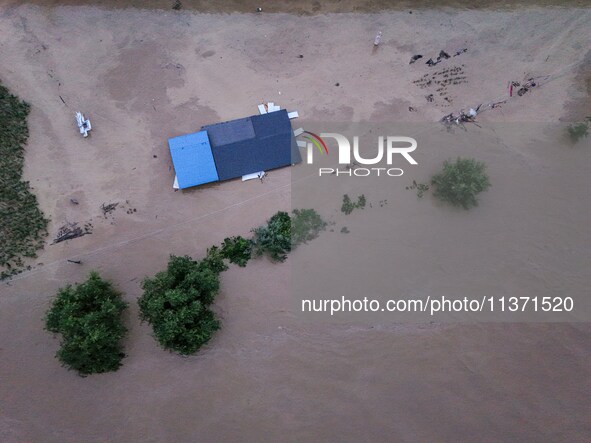 Aerial photo is showing houses and fields along the Wuyang River's Cenggong and Zhenyuan Yangping sections being flooded in Qiandongnan Pref...