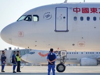 Ground staff are making preparations for a China Eastern Airlines A320 at Yantai Penglai International Airport in Yantai, China, on June 28,...