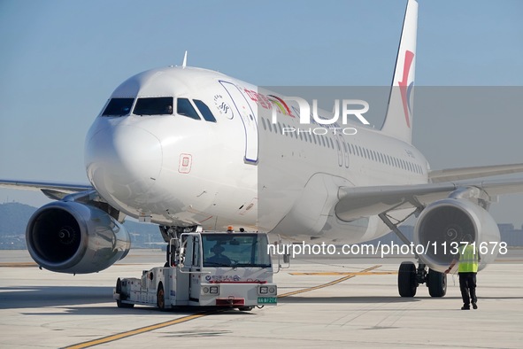 Ground staff are making preparations for a China Eastern Airlines A320 at Yantai Penglai International Airport in Yantai, China, on June 28,...