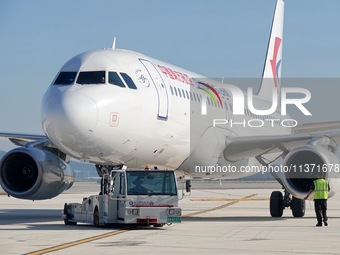 Ground staff are making preparations for a China Eastern Airlines A320 at Yantai Penglai International Airport in Yantai, China, on June 28,...