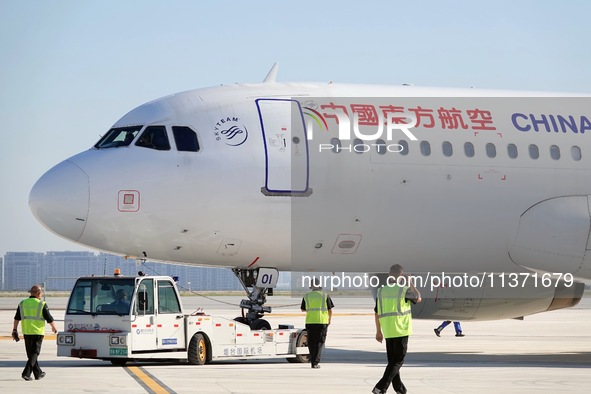 Ground staff are making preparations for a China Eastern Airlines A320 at Yantai Penglai International Airport in Yantai, China, on June 28,...