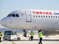 Ground staff are making preparations for a China Eastern Airlines A320 at Yantai Penglai International Airport in Yantai, China, on June 28,...