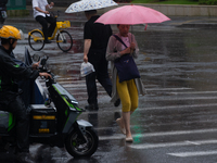 A woman is walking with an umbrella in stormy weather in Shanghai, China, on June 30, 2024. (