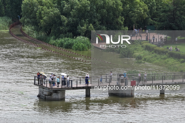 A flooded walkway is being seen after the Yangtze River is exceeding its warning level in Nanjing, Jiangsu province, China, on June 30, 2024...