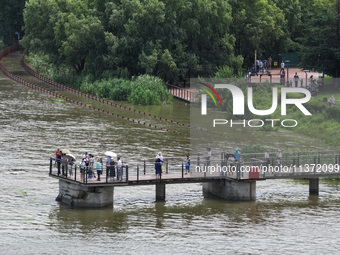 A flooded walkway is being seen after the Yangtze River is exceeding its warning level in Nanjing, Jiangsu province, China, on June 30, 2024...