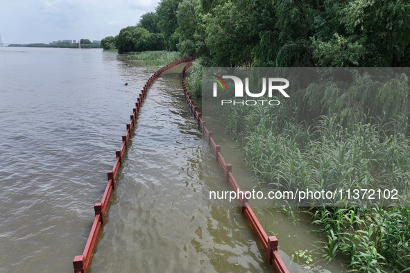 A flooded walkway is being seen after the Yangtze River is exceeding its warning level in Nanjing, Jiangsu province, China, on June 30, 2024...