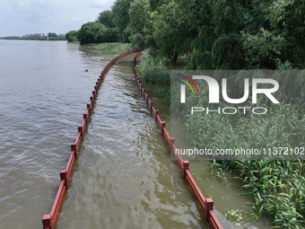 A flooded walkway is being seen after the Yangtze River is exceeding its warning level in Nanjing, Jiangsu province, China, on June 30, 2024...