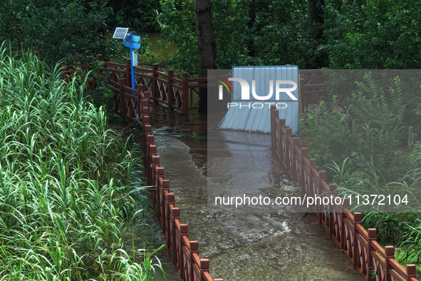 A flooded walkway is being seen after the Yangtze River is exceeding its warning level in Nanjing, Jiangsu province, China, on June 30, 2024...